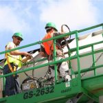 Commercial painting by 2 workers on a forklift